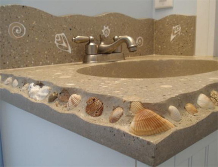 custom concrete sink vanity with seashells embedded in edges