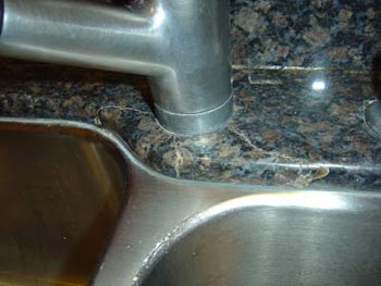 crack in granite countertop due to faucet over tightening