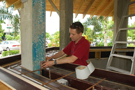 man placing rebar in gazebo before casting concrete countertop