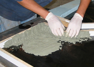 hand packing in stiff concrete countertop mix into form