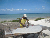 person grinding concrete countertops on beach in Bahamas