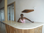 woman standing behind curved concrete countertop