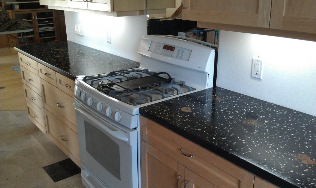 black concrete countertop with mother of pearl and trilobite fossils