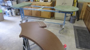 custom concrete table and bench shaped like boot in shop