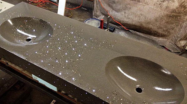 concrete sink vanity with two integral sinks, fiber optic lighting and embedded decorative stone aggregate