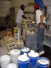men in concrete countertop shop weighing sand and cement for concrete countertop mix