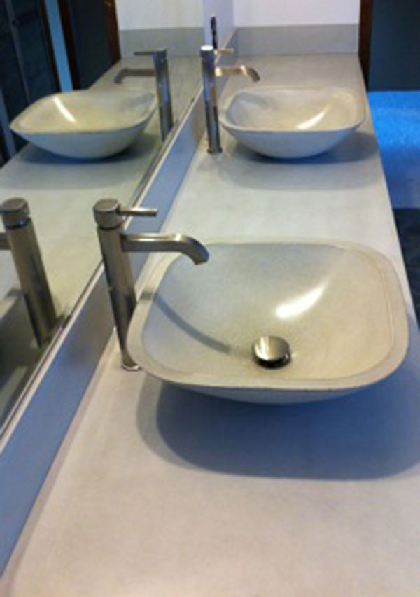 gray concrete countertop with two gray concrete sink vessels