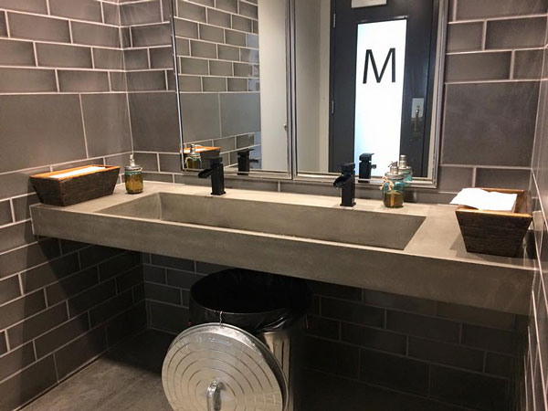 gray concrete sink ramp commercial bathroom