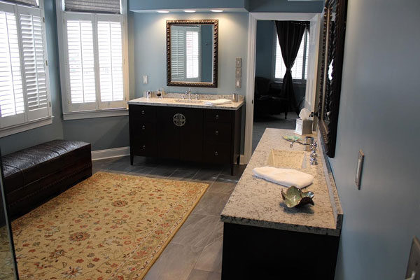 large bathroom with 2 black vanities with concrete countertops and integral concrete sinks