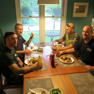 four men having dinner at kitchen table