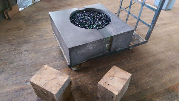 gray concrete fire pit with black fire glass