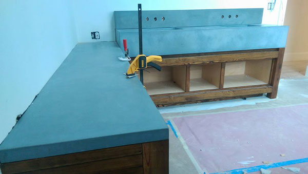 concrete countertop and concrete sinks being installed using clamps