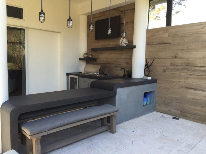 outdoor kitchen with curved concrete bartop multi level