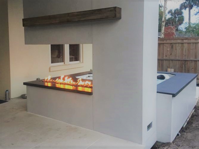 outdoor kitchen with concrete countertop and built in fire table