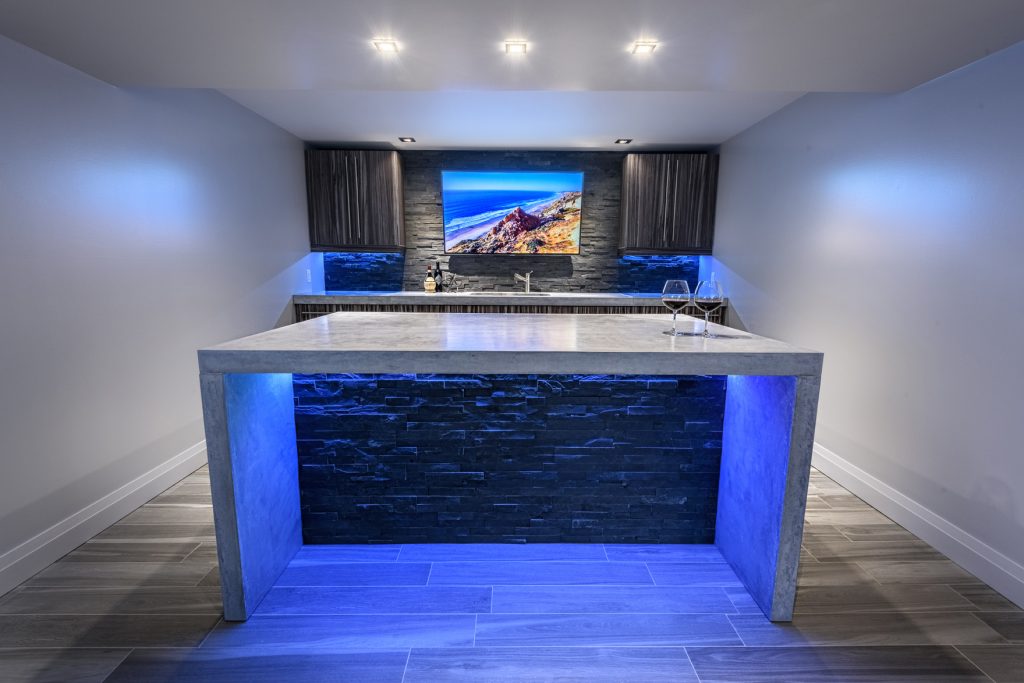 large concrete bartop table with blue lighting underneath